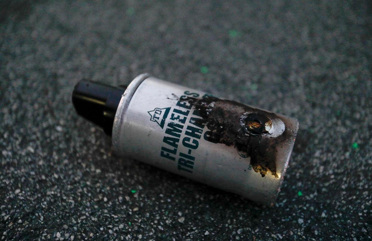 A tear gas canister lies on Santa Rosa Street. Over a hundred San Luis Obispo police officers, sheriff deputies and officers from other agencies guard the streets around the SLO PD station after the protesters were finally dispersed about 8 p.m. Monday, June 1, 2020.