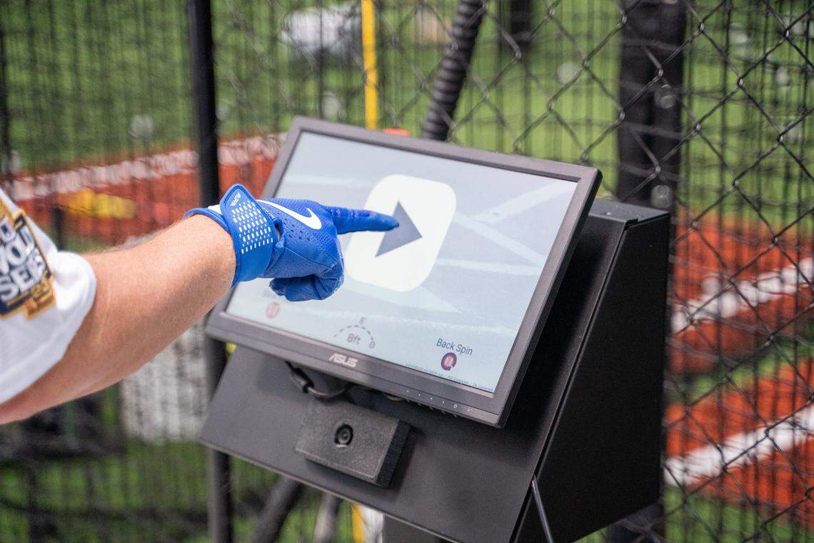 Tribune editor Joe Tarica enters information for what pitch he wants to hit at a pitching simulator at SLO Swing Sports in Grover Beach on Friday, Oct. 10, 2025. Using a touchscreen kiosk, players can set how pitch type, speed and placement to sharpen their skills.