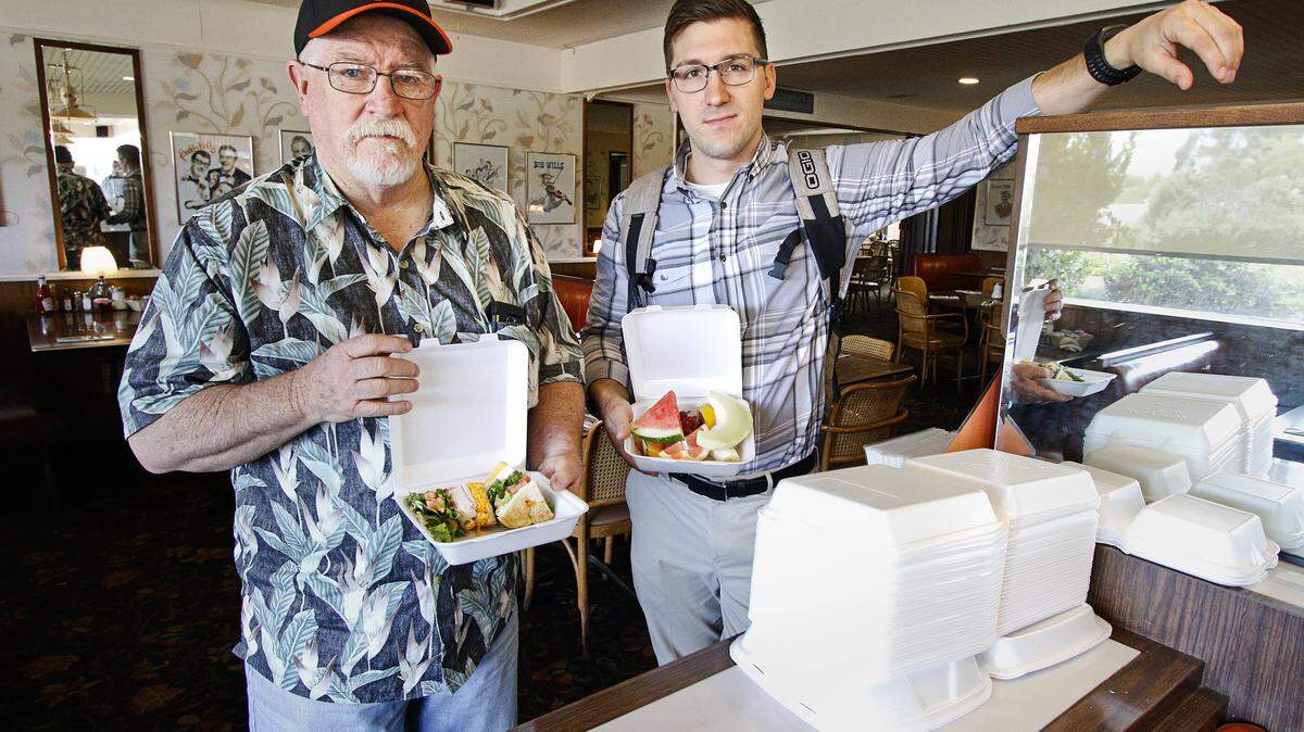 Terry Mullikin, left, and Jake Bitter pose with their leftover lunches packed into Styrofoam containers at Margie's Diner in San Luis Obispo. Owner Marjorie Johnson says she goes through 800 to 1,000 Styrofoam containers a week.