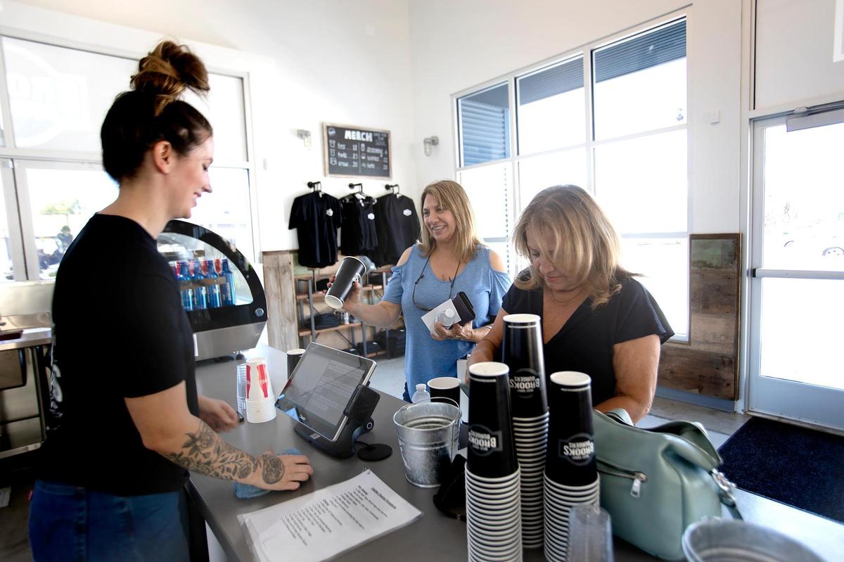 Brooks Burgers recently opened in San Luis Obispo. Emily Kasner, bartender and cashier, helps customers.