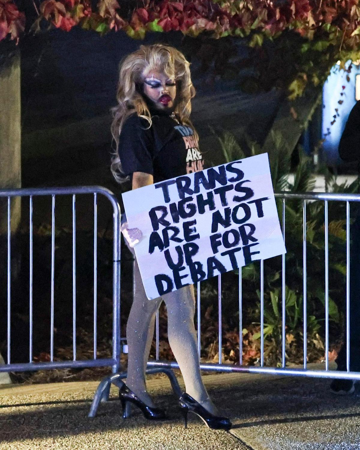 Vinny Torres who performs as “Skinny Mocha” holds a sign that says “Trans rights are not up for debate.”