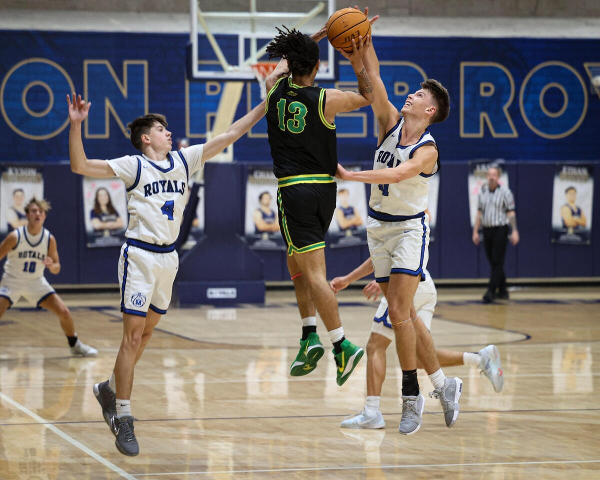 James Miller is caught in the trapping defense of Brody Miller, left, and Roman Benedetti. Mission Prep beat Roosevelt 80-52, in a boys’ playoff basketball game on Feb. 19, 2025.