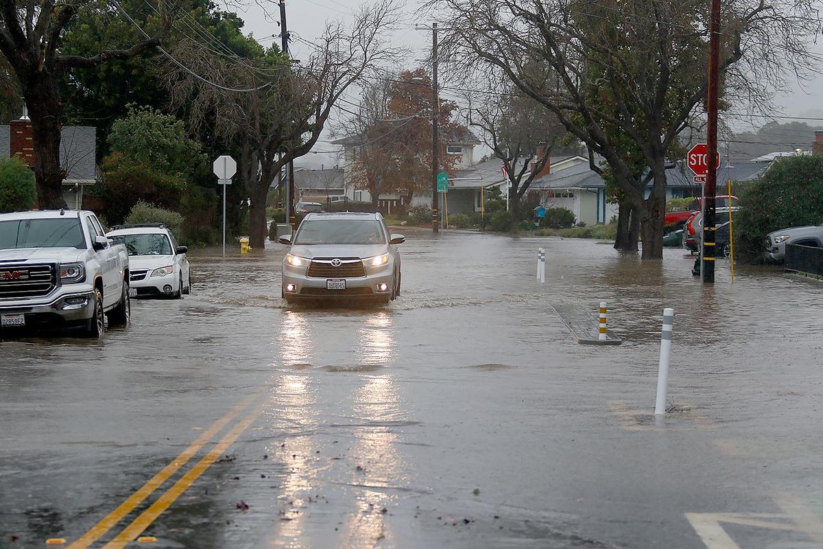 Oceanaire Drive is flooded with Laguna Lake water. The lake is up to the sidewalk on Madonna Road.
