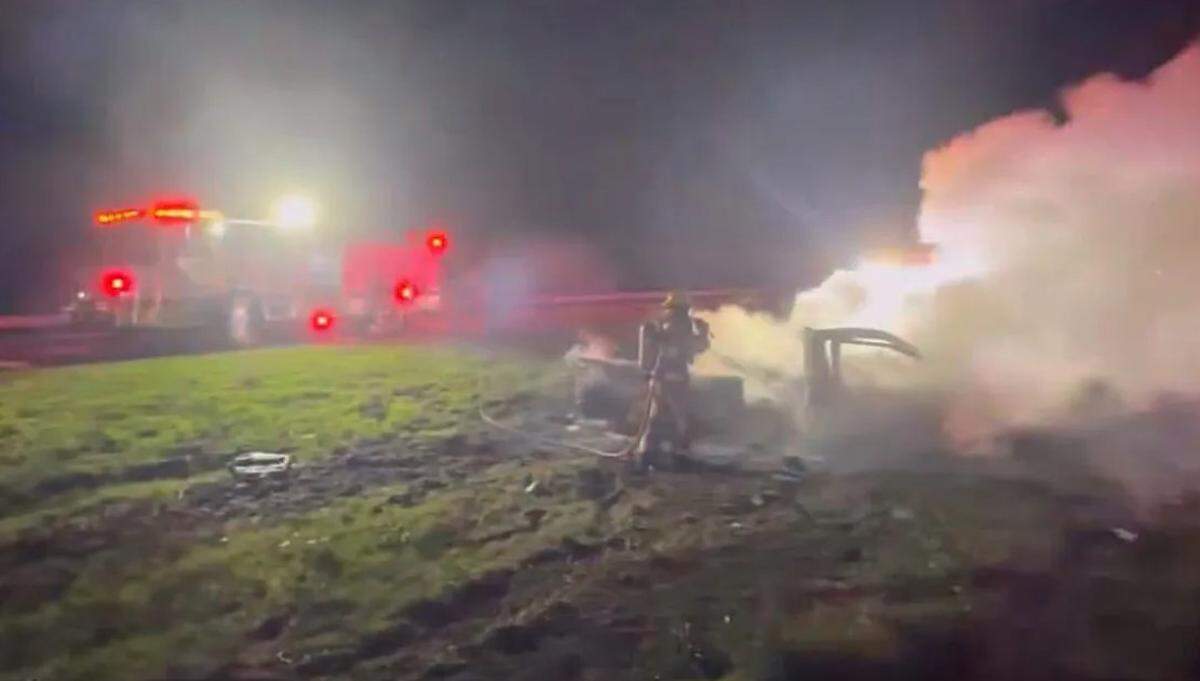 A firefighter sprays water on a pickup truck that caught fire after a crash on the morning of Jan. 5, 2024. The CHP is investigating the fatal collision.
