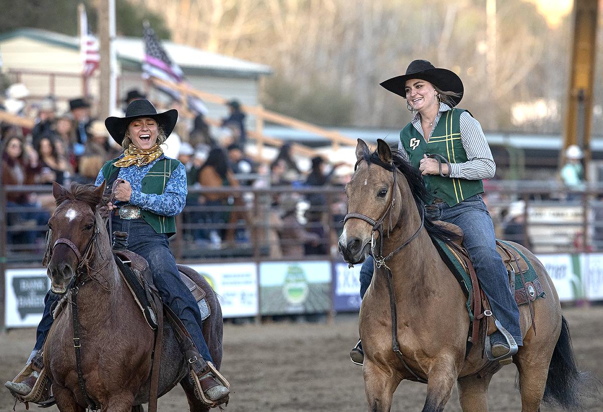 Cal Poly Rodeo Team members Paula Cooper, left, Samantha Massey sport happy smiles after Massey took the lead in the breakaway competition at the Poly Royal Rodeo on Saturday, April 15, 2023, which she went on to win. The 81st annual Poly Royal Rodeo was held Friday and Saturday, April 14 and 15, 2023, at the Cotton Rosser Rodeo Complex in San Luis Obispo.