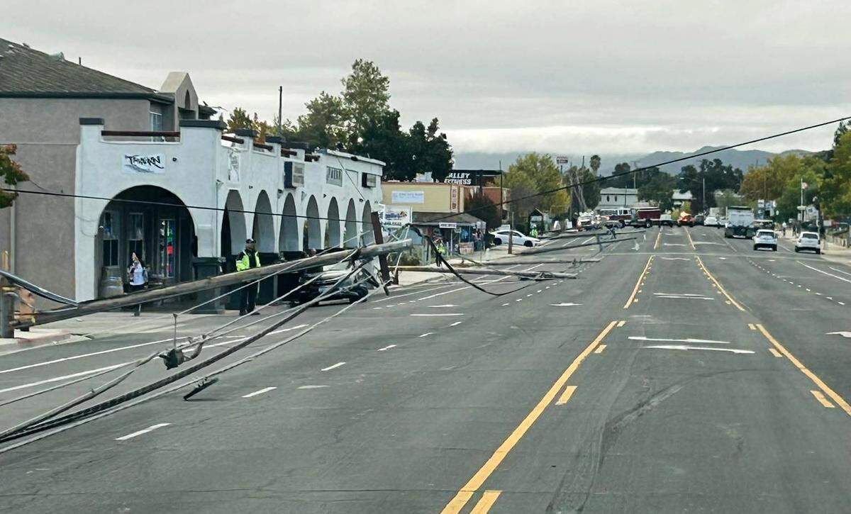 Utility poles and lines were knocked down and scattered in the street on El Camino Real in Atascadero on Oct. 27, 2025, closing half of the city’s main drag to traffic.