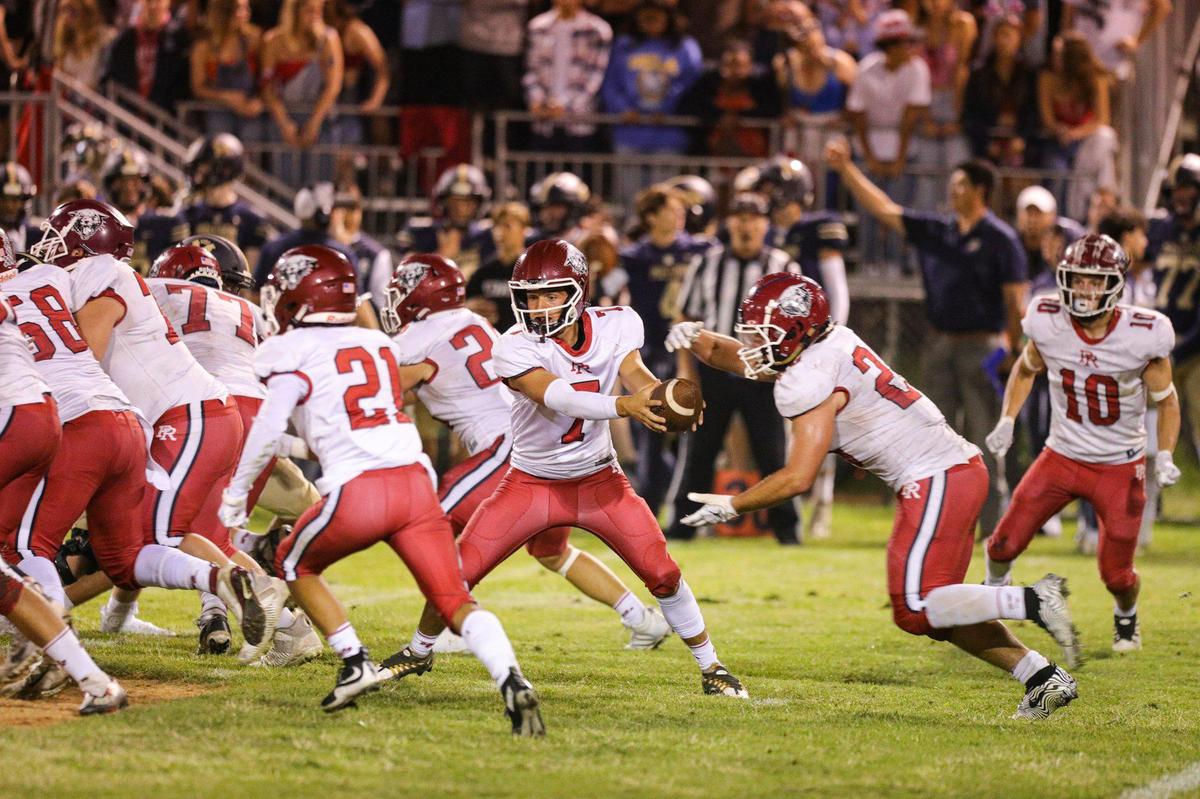 Tyler Luna hands off to Leo Kemp. Mission Prep defeated Paso Robles 28-7 in a football game on Sept. 30, 2022, in San Luis Obispo.