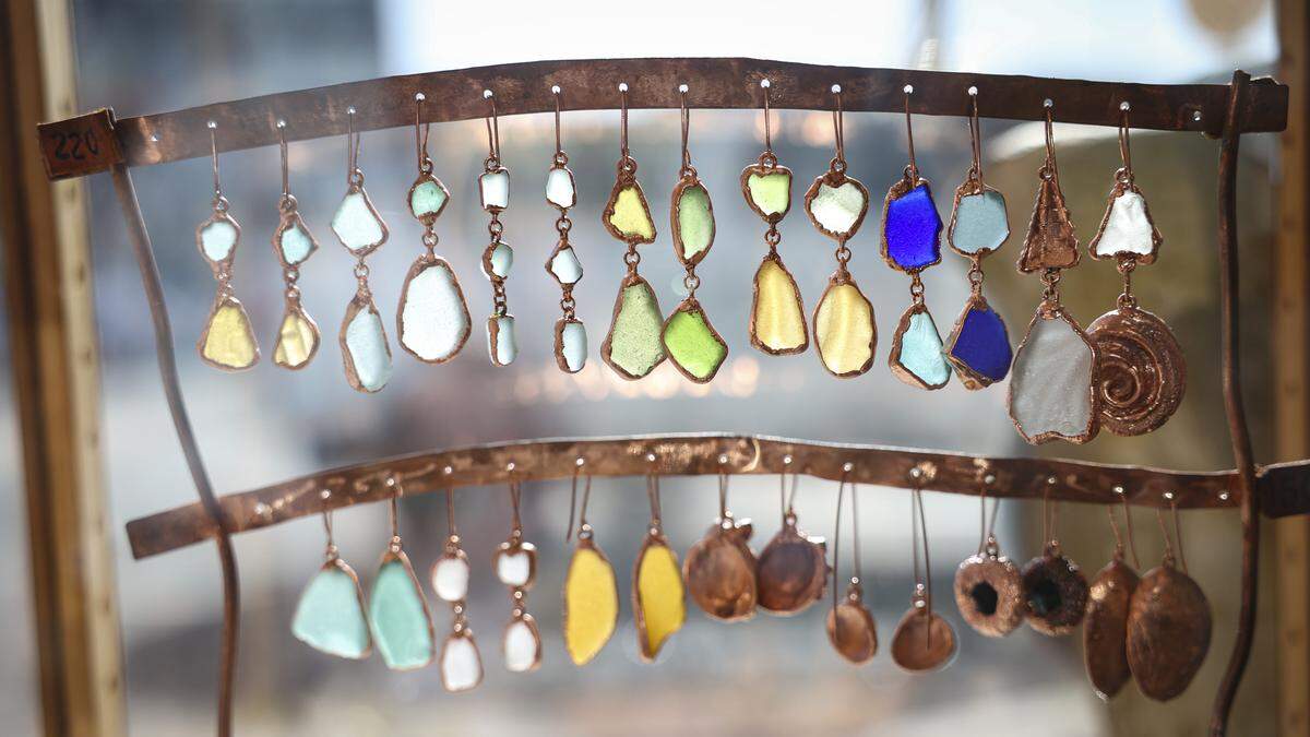 Meagan Gittins uses metals and nature-inspired objects to create jewelry, like these sea glass and sea shell earrings, at Artistry by the Sea in Cayucos, seen here on March 16, 2026.