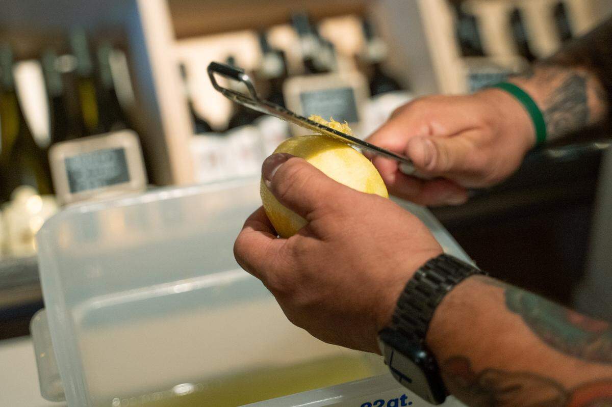 Giuseppe’s Italian American Club distiller Ulisses Avina microplanes lemons in the old bank safe that now serves as the restaurant’s wine storage on Tuesday, May 19, 2026. The deli and restaurant expansion of the existing Giuseppe’s Cucina Italiana in Pismo Beach recently started its own offshoot brand of limoncello.