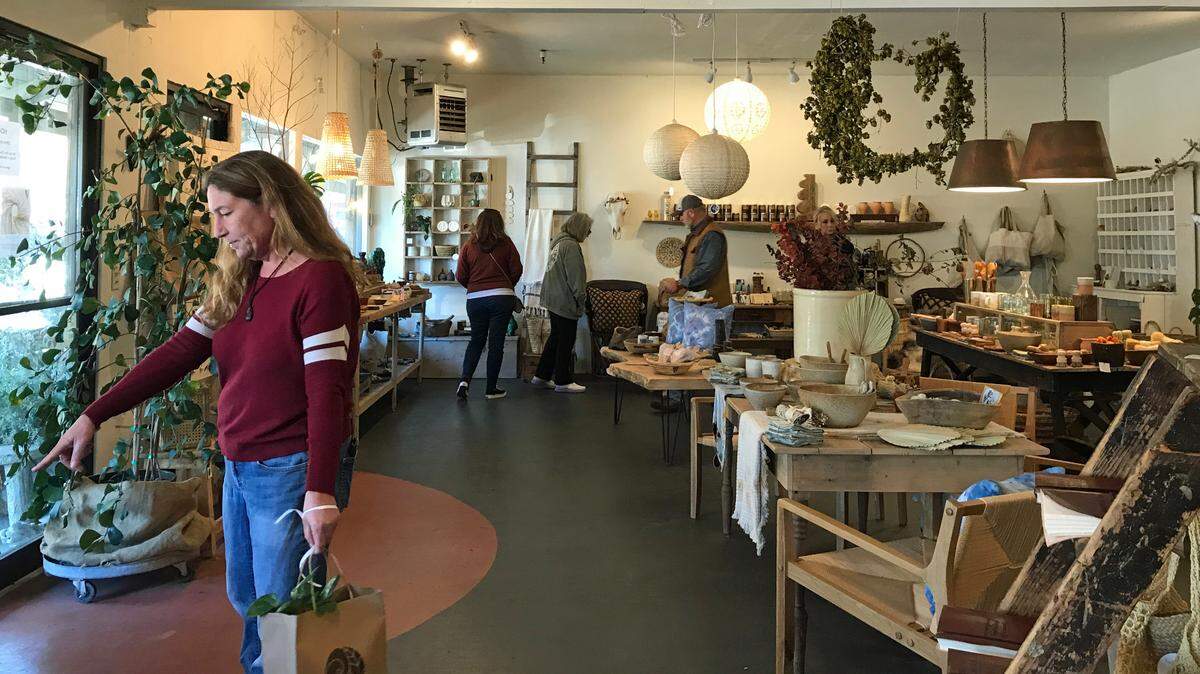 Shoppers browse at Sea + Green in Cambria on Saturday, Nov. 12, 2022.