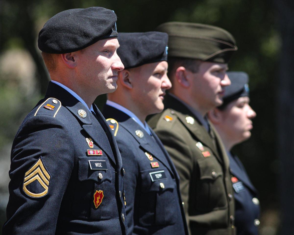 Members of the USASA Honor Guard from Camp Roberts stand at attention, from left, Cody Wise, Arseniy Tepp, Keegan Shilling and Sarah Goodloe, at the Paso Robles District Cemetery on Memorial Day, May 30, 2022.