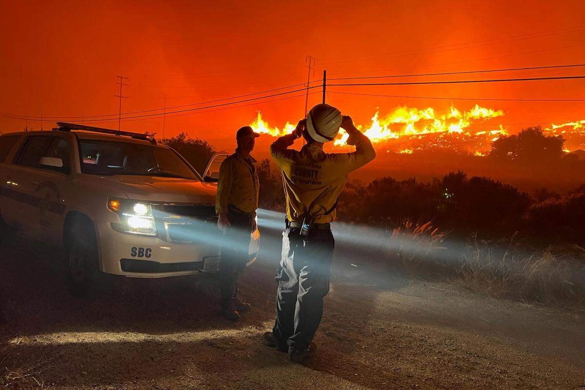 Santa Barbara County firefighters respond to the Alisal Fire burning late Monday night near Refugio Road. The blaze grew to 6,000 acres overnight.
