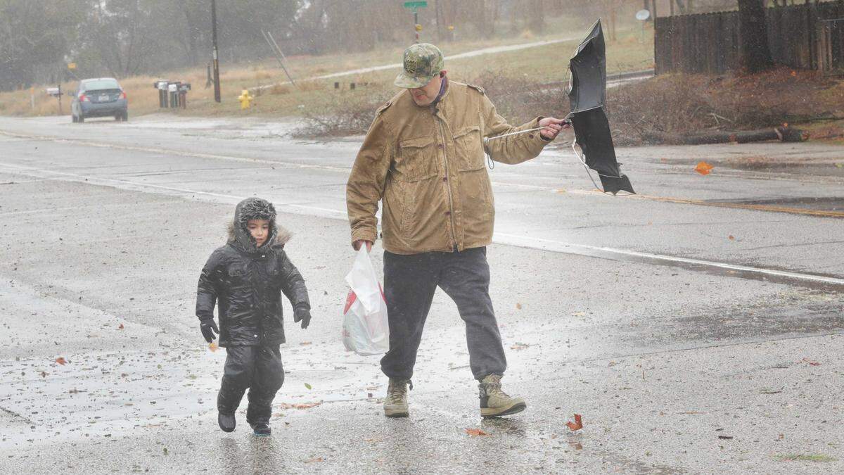 Gabriel Cortez and son Alexander 4, walk home on El Camino Real in Atascadero after shopping for groceries on Wednesday, Jan. 27, 2021. Alexander was dressed in a snowsuit and was enjoying the adventure.