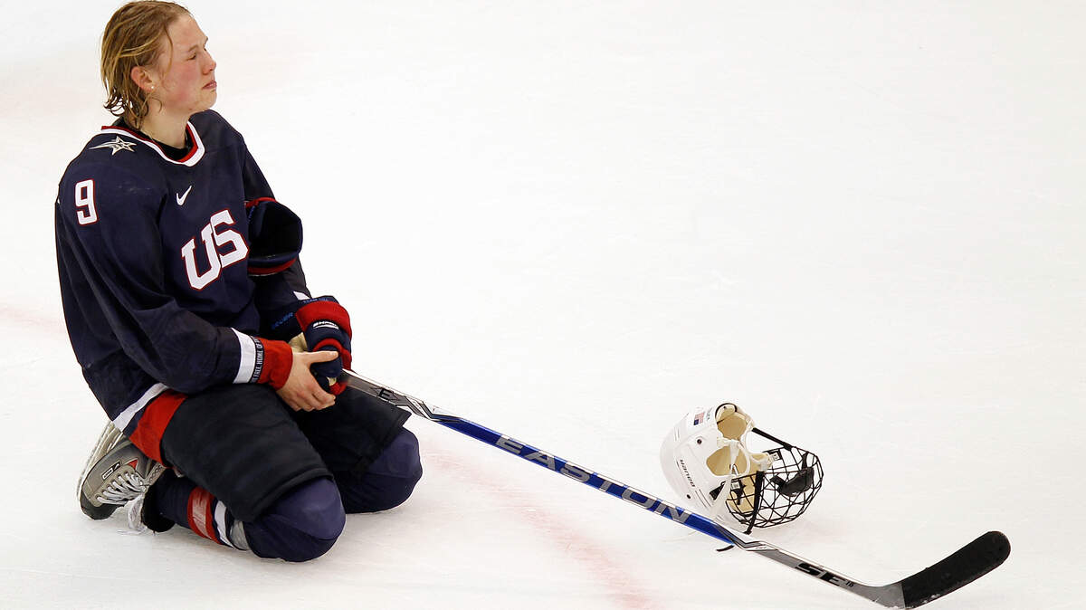 USA's Molly Engstrom watches with tears in her eyes as Team Canada celebrates their victory in the women's gold medal hockey game. The USA took the silver medal. (Harry E. Walker/MCT)