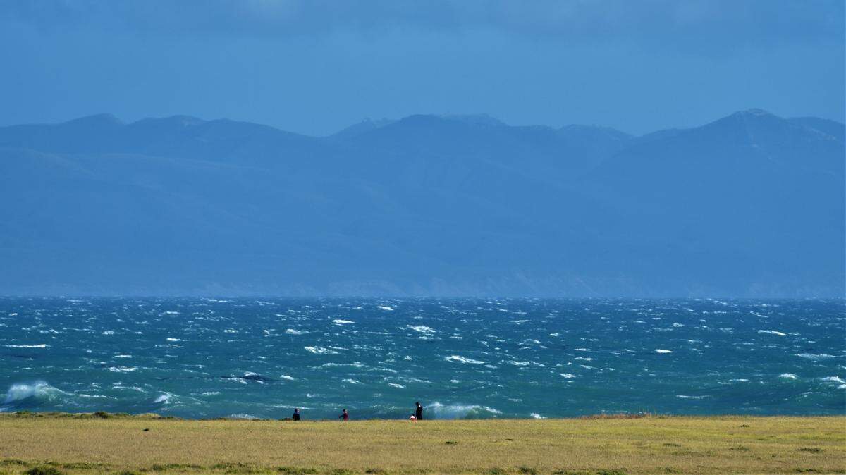 Northwesterly winds kick up whitecaps and rough seas across Estero Bay.