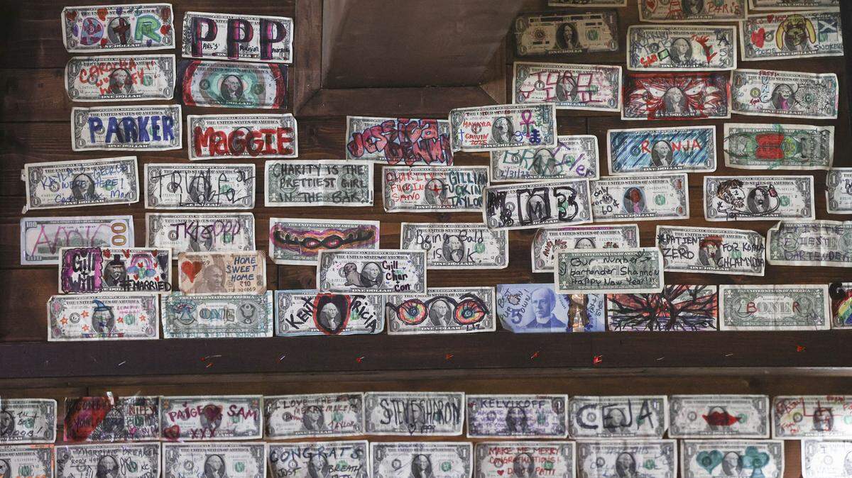 Artwork on dollar bills are stapled to the wall at Niffy's Merrimaker in Baywood-Los Osos seen here on Aug. 18, 2025.