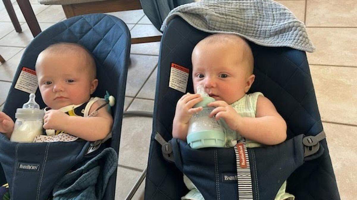Four-month-old twins Larkin Citrin, left, and Bennett Citrin drink infant formula from their bottles. Larkin Citrin can only tolerate Similac Pro Sensitive formula, which is part of a nationwide recall and has been nearly impossible to find in stores.