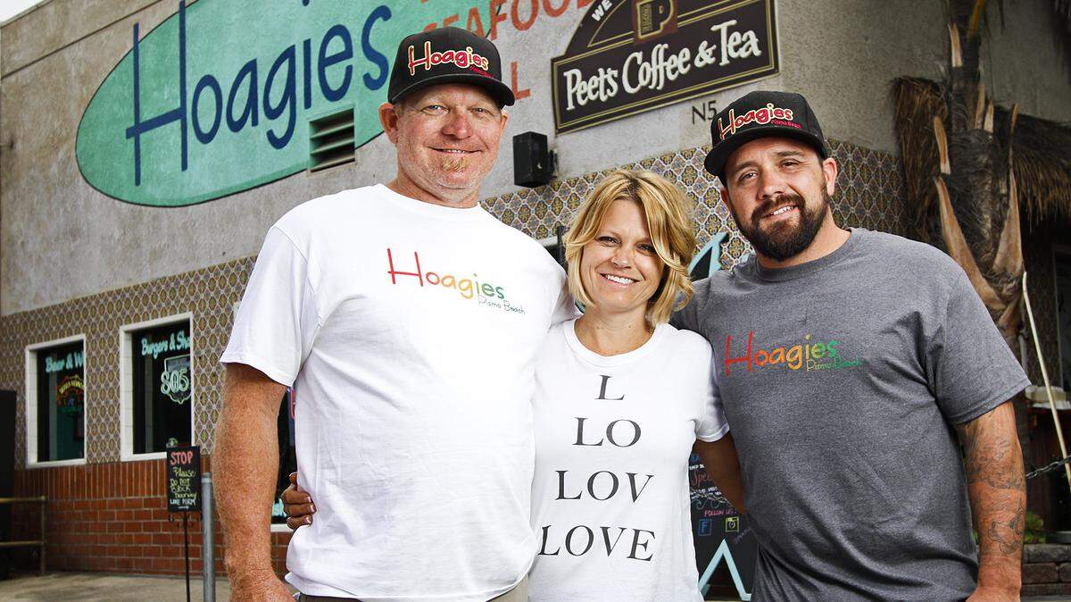 Jason Joseph, left, his wife, Kacey, and Nick Stieb are the owners of Hoagies, a Rasta-themed restaurant in Pismo Beach.