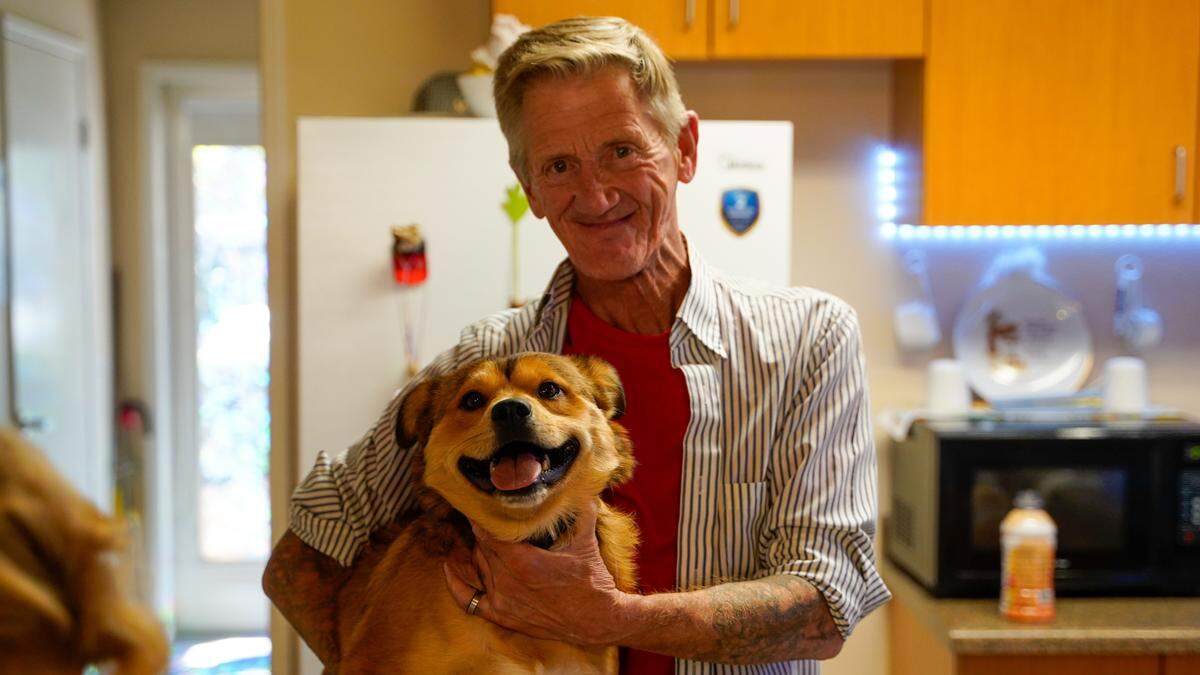 Frank Morrell holds Chawea, a dog owned by Paso Robles resident Deborah Marino, at Marino’s senior living apartment. Marino spent more than six years homeless in San Luis Obispo County while battling cancer, moving from encampment to encampment.