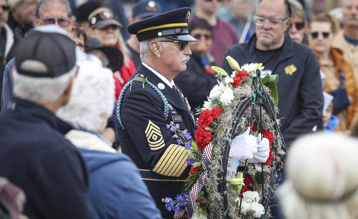 First Sgt. Joe Martinez, Retired places a wreath. About 200 people attended a Veterans Day Celebration at the Pismo Beach Pier on Nov. 1, 2025.
