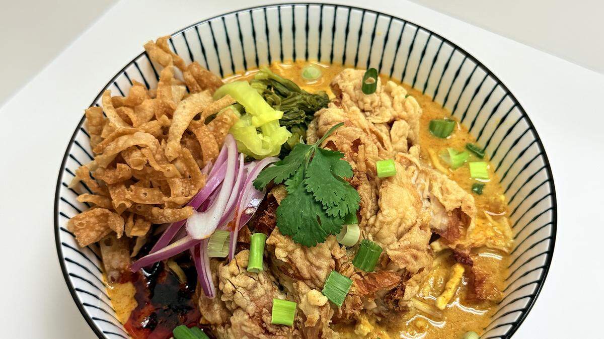 The Khao Soi, available at Infused Thai Fusion Kitchen, is an egg noodle soup served in a curry broth with red onions, pickled mustard, chili oil and fried wontons.