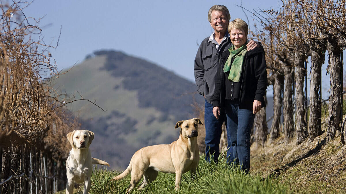 Doug and Nancy Beckett pose with their dogs Hardy, left, and Gretta at Peachy Canyon Winery in Paso Robles.
