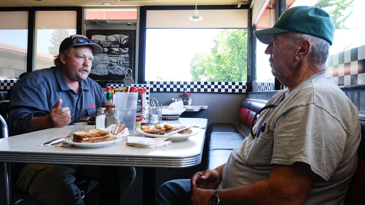 Chance Simmons, left, and Rodger Snyder talk while enjoying lunch at A-Town Diner on Thursday. The restaurant is closing on Sunday after nearly 20 years.
