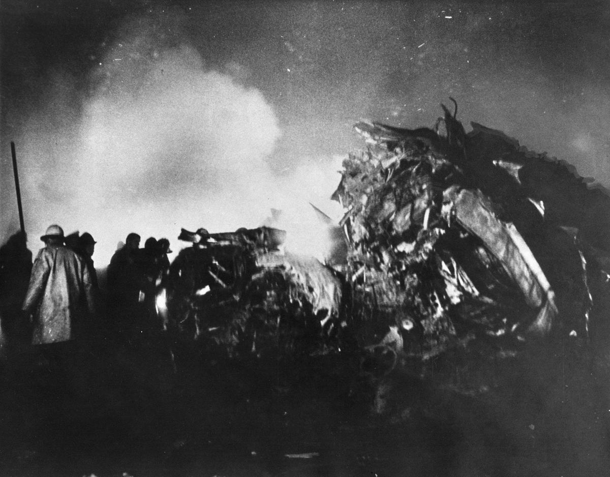 Rescuers respond to the burning wreckage of the Cal Poly football team’s charter plane, which crashed on takeoff from the airport in Toledo, Ohio, on Oct. 29, 1960. Sixteen Mustang football players, the student manager, a member of the Mustang Booster Club, and four others died in the crash.