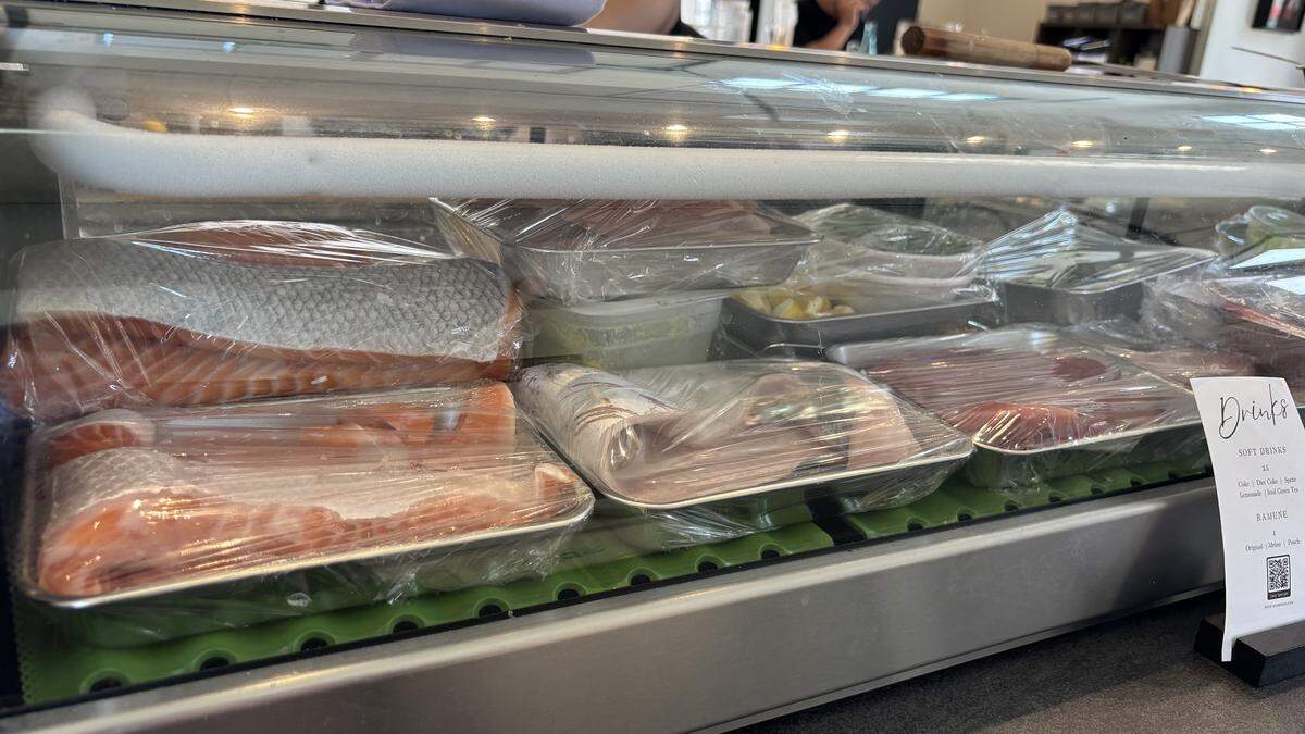 Fresh salmon, tuna and other fish are displayed at Goshi Sushi’s bar. The new spot at the SLO Public Market opened on May 13, 2026, serving nigiri, sashimi and hand rolls.