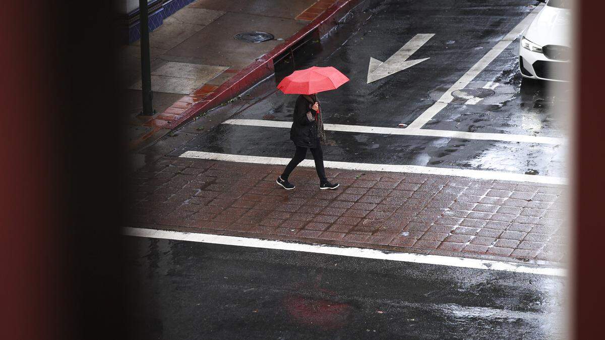 Umbrellas were out downtown in San Luis Obispo at the corner of Chorro and Marsh Streets as rain continues Dec. 26, 2025.