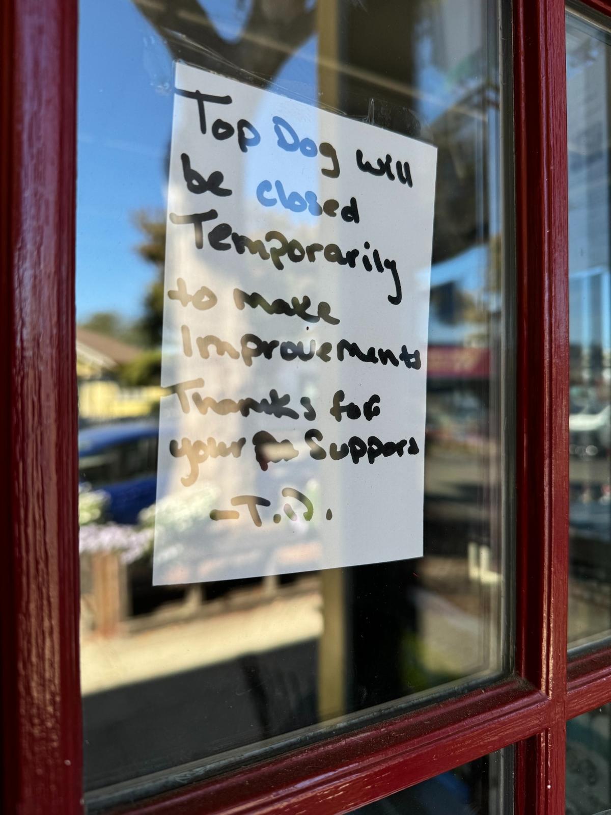 A note posted on Top Dog Coffee Bar’s front door said that the shop “will be closed temporarily to make improvements. Thanks for your support.”