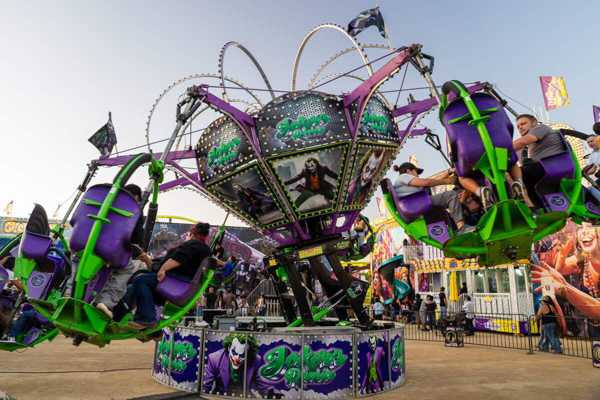 Fairgoers ride a spinning ride at the California Mid-State Fair on July 15, 2026. Temperatures soared past 100 degrees on opening day.