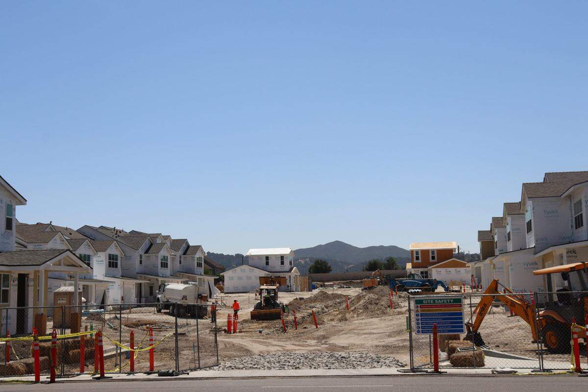A 70-unit housing development at 10850 El Camino Real in Atascadero has led to disputes with neighbors over slow progress. Several unfinished houses line the sand lot at the work project. Neighbors said that in the five years the site has been there, they haven’t seen more than a few workers on-site at a time.