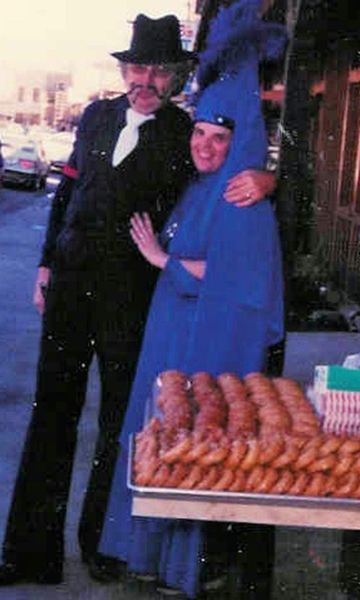A vintage picture shows bakery owners Richard and Kathe Tanner handing out Halloween goodies for parading grammar school students in Cambria.