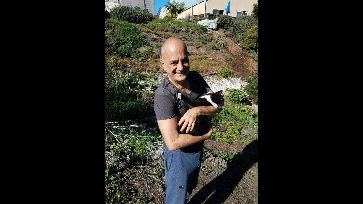 Norman the cat poses for a picture with his owner. Firefighters rescued Norman from a storm drain in Pismo Beach on Wednesday, Nov. 16, 2022.