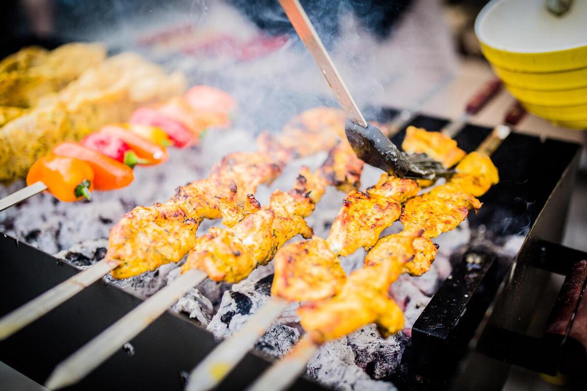 Chicken skewers cooking over charcoal on a barbecue grill. Shekamoo Grill celebrated its grand opening at SLO Ranch Farms & Marketplace in late January 2025. The new restaurant is one of the first Persian cuisine spots in San Luis Obispo.