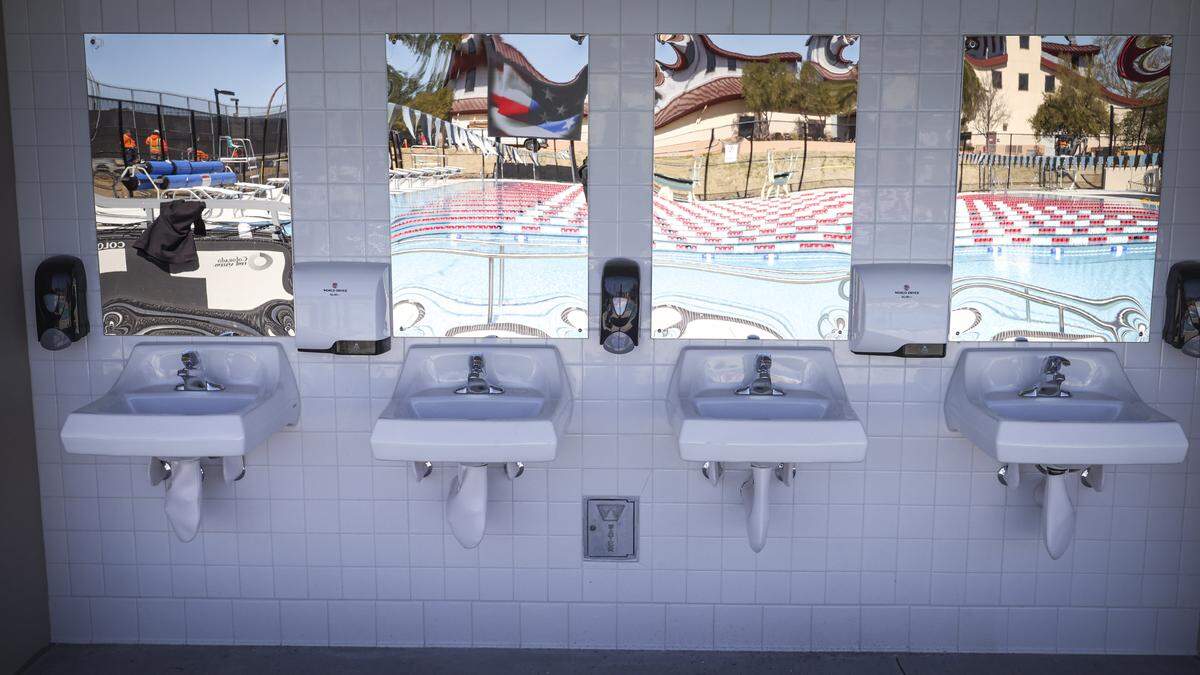 The pool deck is reflected in mirrors behind outdoor sinks. The eagerly anticipated aquatic center at Paso Robles High School was undergoing final finish work on March 5, 2026, the day before dedication.