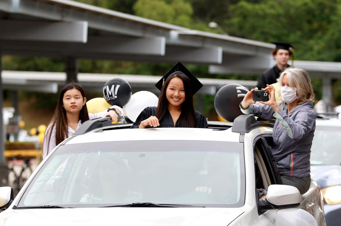 Julia Voss smiles as she rides up to the podium in her familyÕs car. San Luis Obispo High School held a drive-through graduation ceremony for the 367 graduating student on Friday, June 5, 2020.