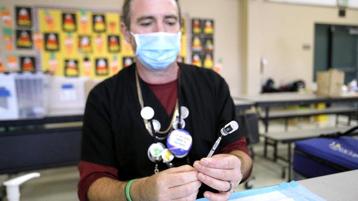 San Luis County Health Department Psych Tech John “Mike” Jamison readies COVID-19 vaccination syringes. The health department conducted a pop-up vaccination clinic at Santa Rosa Academic Academy in Atascadero, Friday, Nov. 3, 2022.