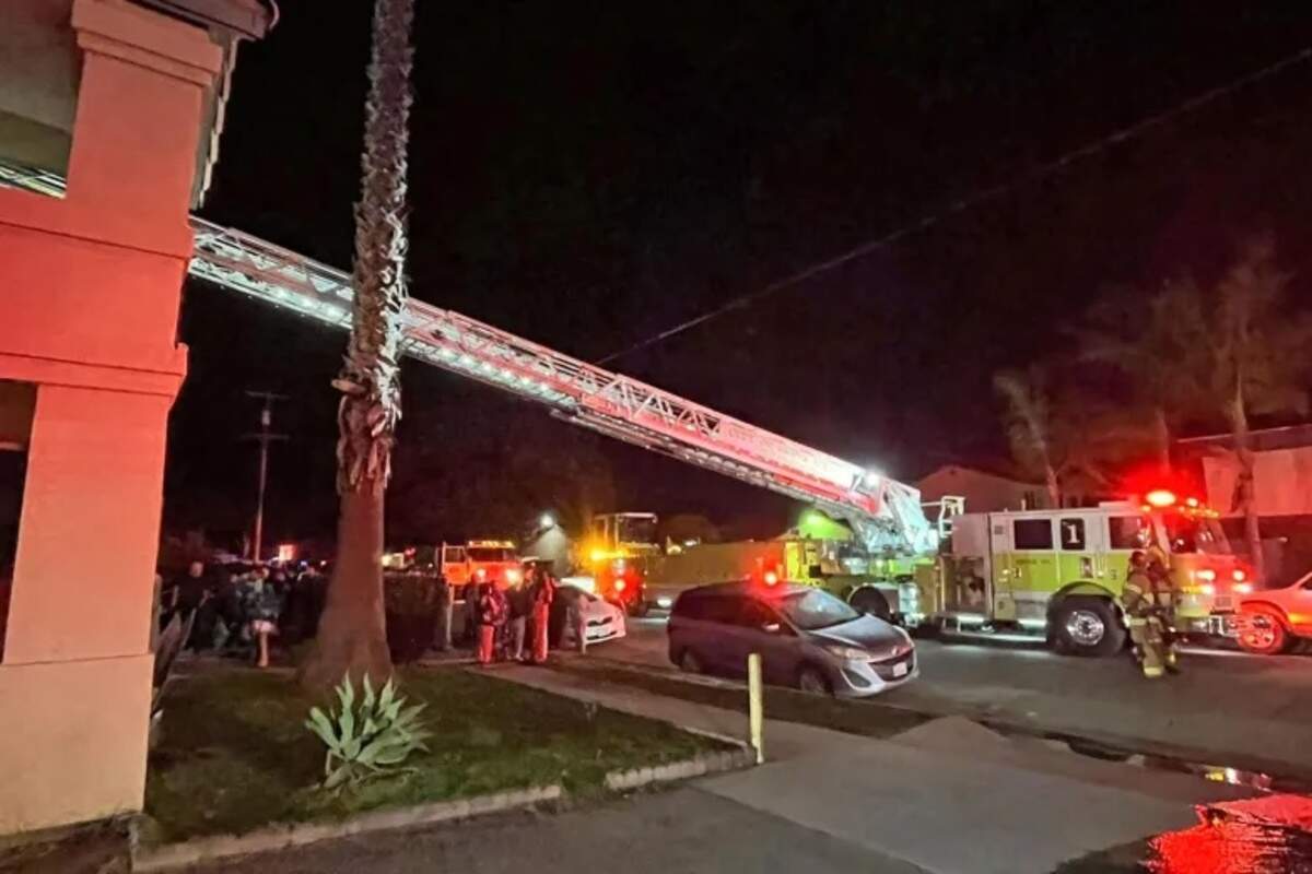 Firefighters battle a blaze in parking stalls underneath the Twin Palm Apartment on the 300 block of East Bunny Avenue early Sunday morning, Feb. 22, 2026.