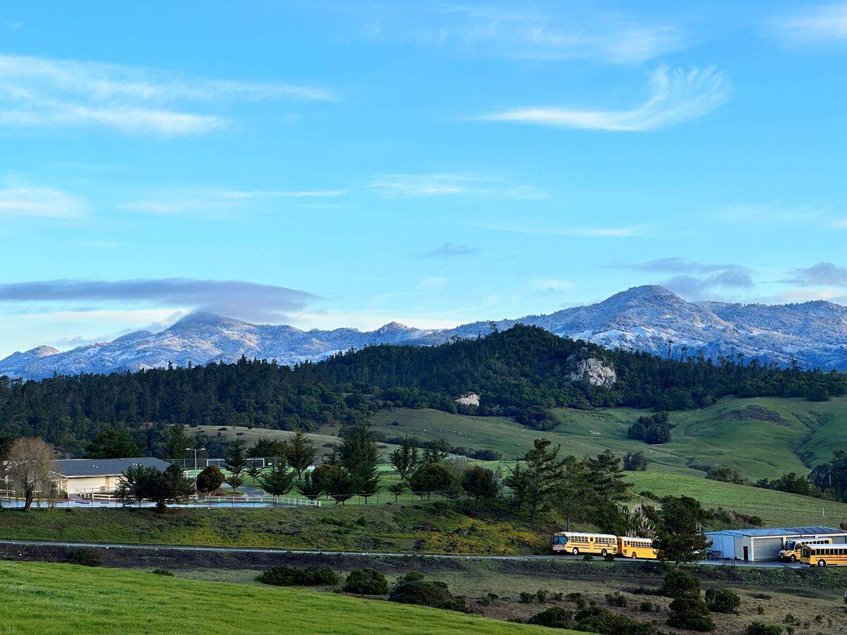 Lorienne Schwenk, executive director of the Cambria Chamber of Commerce, shot this photo of snow on the surrounding hills on Thursday, Feb. 23, 2023. This view overlooks Santa Lucia Middle School in Cambria.