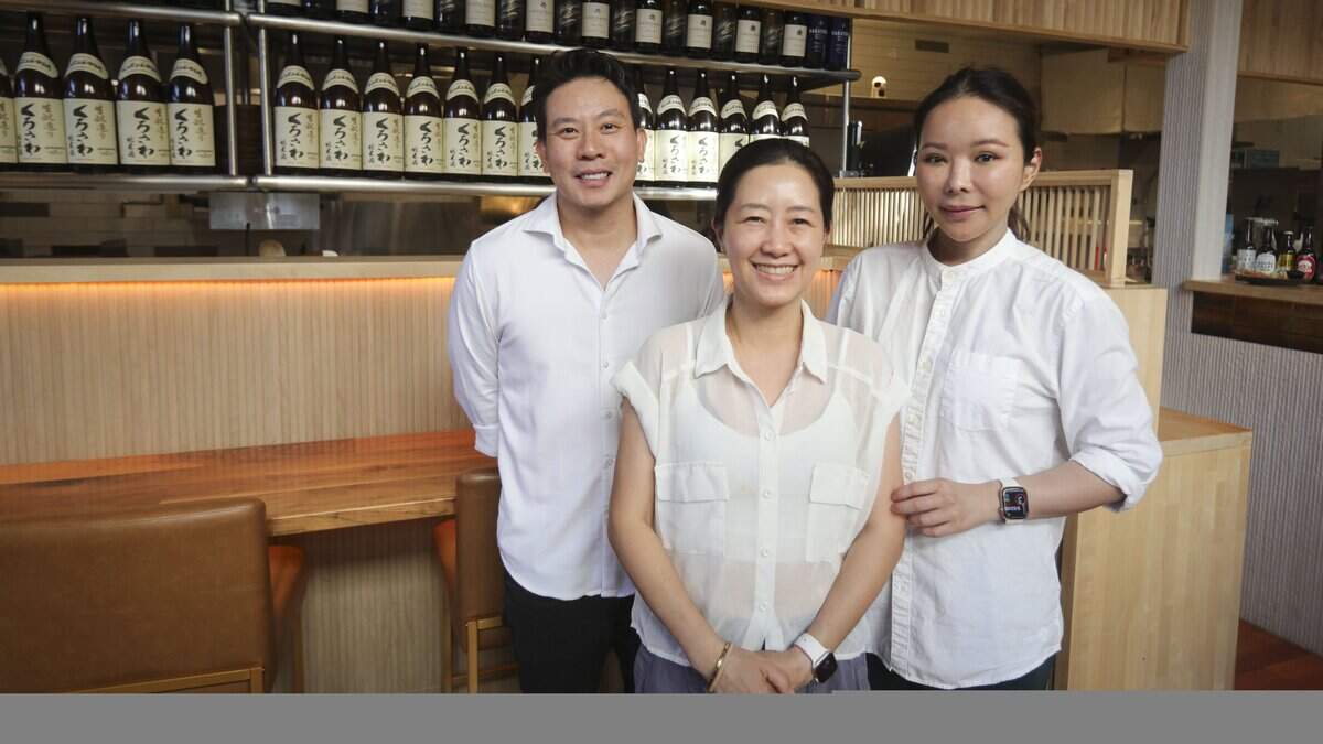 Amphida Nishimura at center front with Charles and Thanya Pokpoonpipat, co-owners of Nomo Domo. The restaurant is open in downtown SLO, on Monterey Street near the Mission. They serve ramen and side dishes, seen here on Sept. 3, 2025.