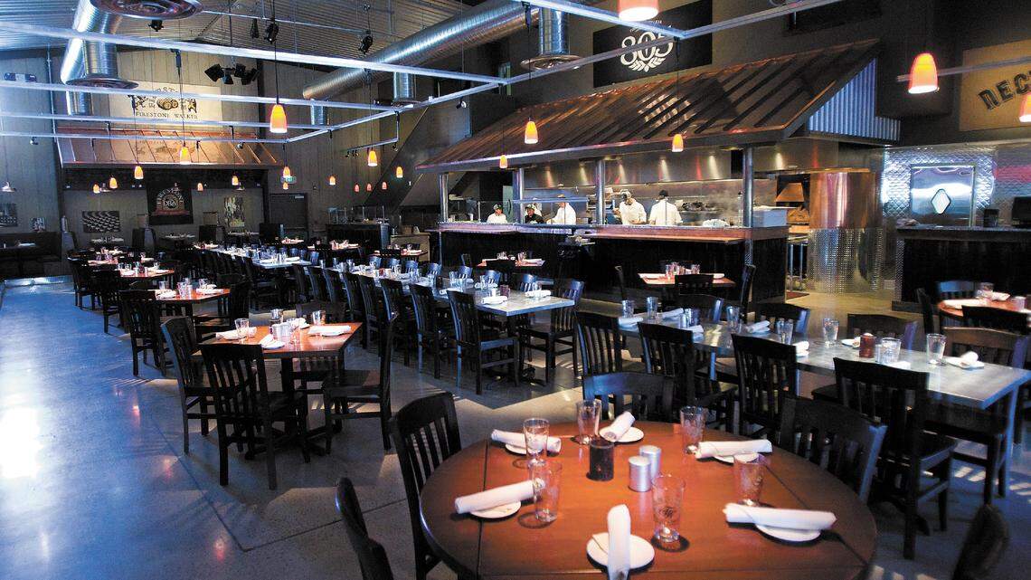 The Taproom’s 7,500-square-foot space occupies an old industrial building that has been transformed into a modern dining room featuring brushed steel, corrugated metal, rustic wood and copper details.