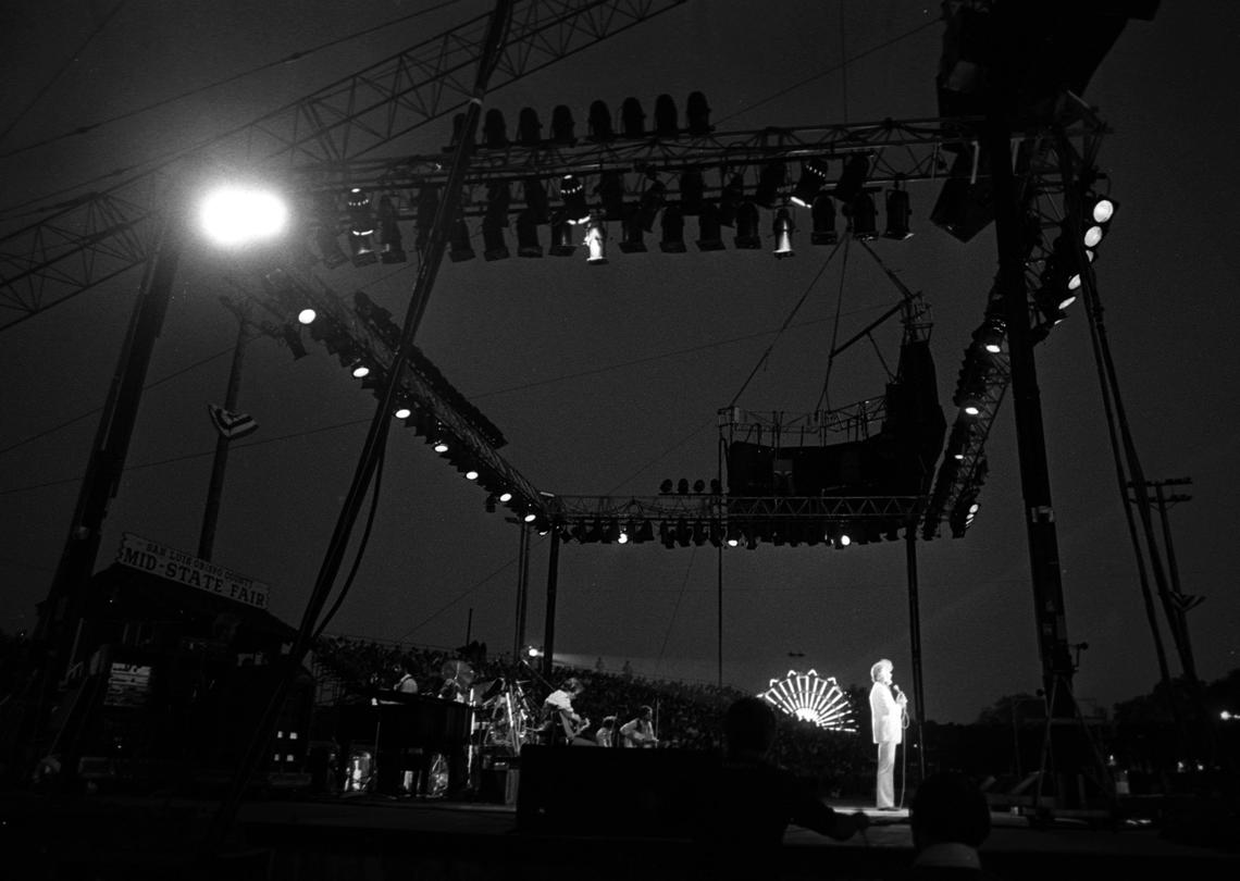 Kenny Rogers arrives in a helicopter, and is lowered to the California Mid-State Fair stage from the hovering craft to the wild cheers of his fans on Aug. 7, 1982.