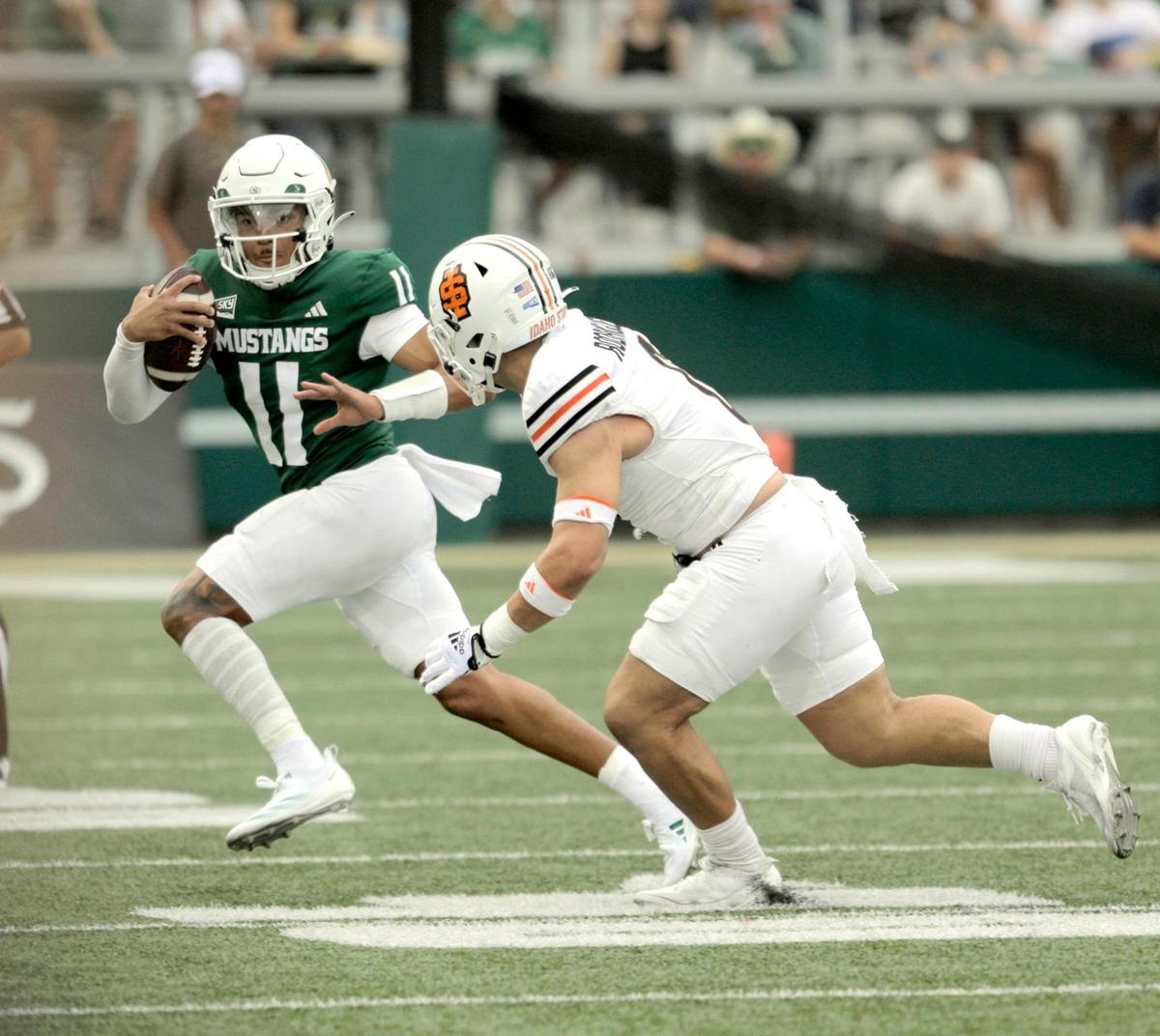 Quarterback Jaden Jones runs with the ball under pressure by Adrian Rodriguez. Cal Poly lost to Idaho State 41-38 in a college football game at Mustang Memorial Stadium on Oct. 5, 2024