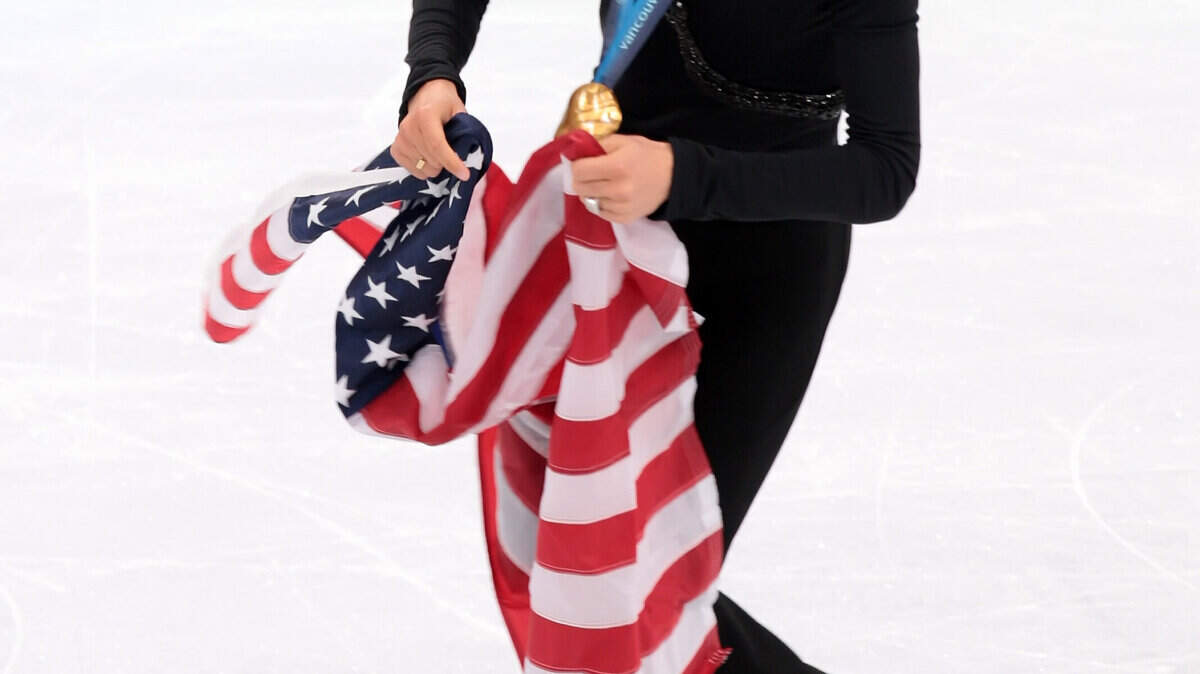 Evan Lysacek of the United States celebrates his gold medal in men's figure skating. (George Bridges / MCT)