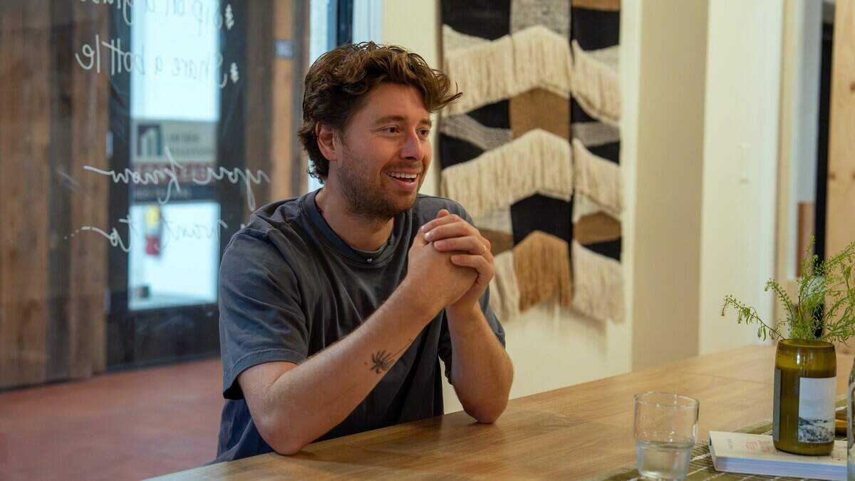 ídola wine co. co-owner Ryker Wall sits in the business' new tasting room at the Creamery in San Luis Obispo on July 14, 2026. The company specializes in producing and selling organic, all-natural wines.