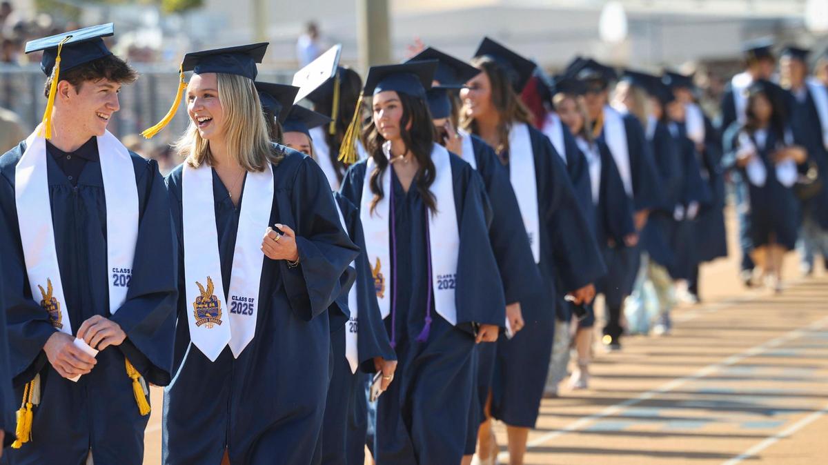 From left, Ryan Payne and Dana Petker walk into the football stadium. Arroyo Grande High School held commencement for 520 graduates on June 5, 2025.