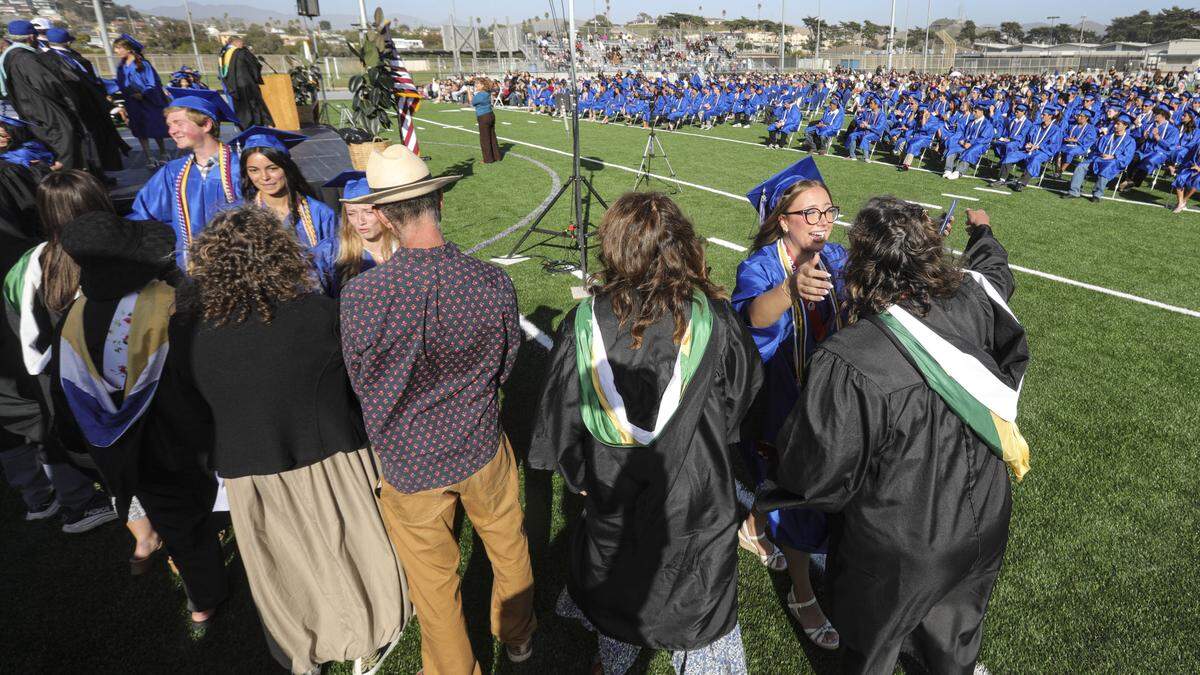 Josslyn Finch gets hug at right. Morro Bay High School issued diplomas to 176 graduates on June 4, 2026.