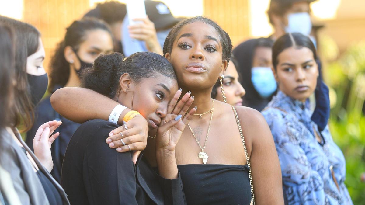 Black Lives Matter activists LeiYahna Jefferson, left and Josephine Agoruah hug after sharing their stories of being hit by a motorcyclist while in a crosswalk on Wednesday. A rally in support of protesters Tianna Arata and Elias Bautista was held at the San Luis Obispo County courthouse, where Arata and Bautista were being arraigned on Thursday, Sept. 3, 2020.